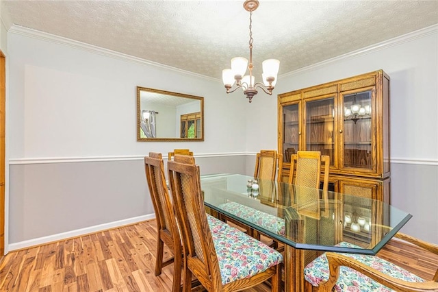 130 Brooklet Way, Brooks, GA 30205 - dining space featuring a chandelier, wood finished floors, a textured ceiling, and ornamental molding