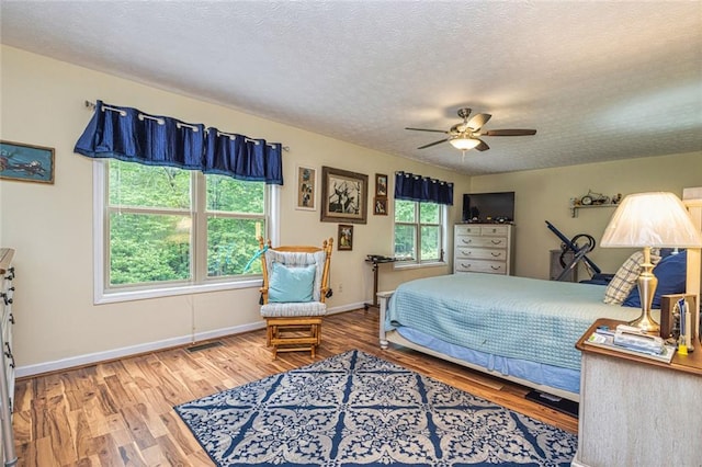 130 Brooklet Way, Brooks, GA 30205 - bedroom with wood finished floors, a textured ceiling, and a ceiling fan