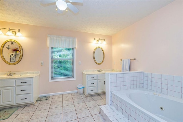 130 Brooklet Way, Brooks, GA 30205 - bathroom with two vanities, a jetted tub, tile patterned flooring, a ceiling fan, and a textured ceiling