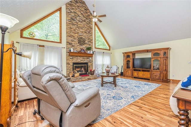 130 Brooklet Way, Brooks, GA 30205 - living room featuring high vaulted ceiling, wood finished floors, a stone fireplace, and a ceiling fan