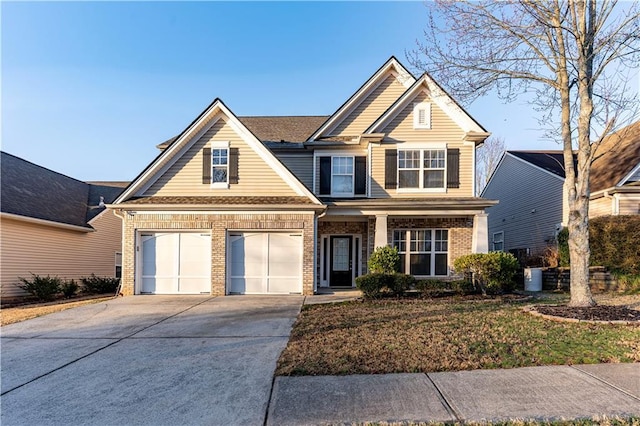 craftsman-style house with brick siding, driveway, and a garage