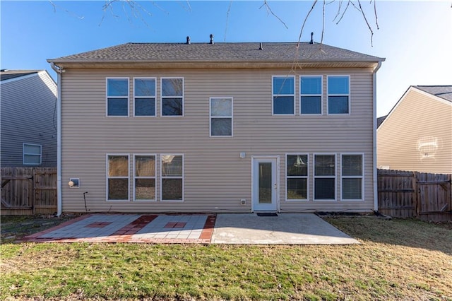 back of property with a patio, a yard, and a fenced backyard