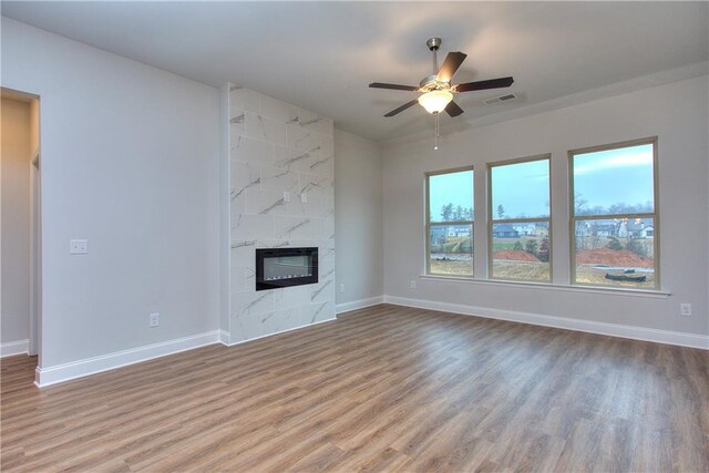 96 Sherwood Dr, Commerce, GA 30529 - unfurnished living room featuring a premium fireplace, baseboards, wood finished floors, and ceiling fan
