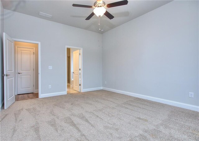 96 Sherwood Dr, Commerce, GA 30529 - unfurnished bedroom with a ceiling fan, connected bathroom, light colored carpet, baseboards, and lofted ceiling