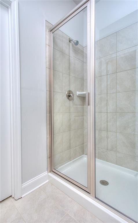 96 Sherwood Dr, Commerce, GA 30529 - bathroom featuring baseboards, tile patterned flooring, and a stall shower