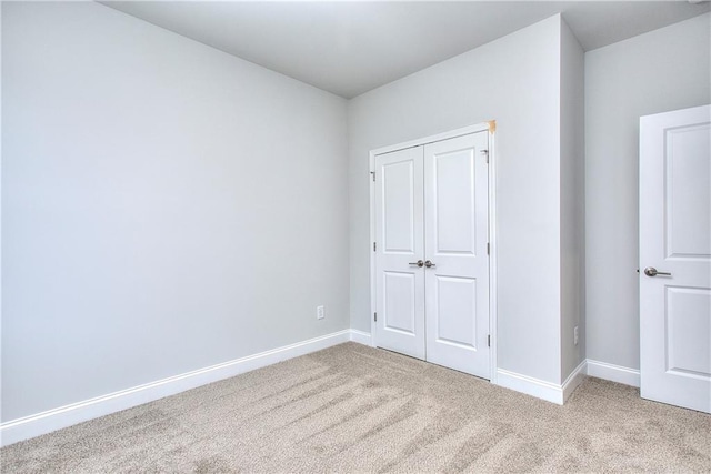 96 Sherwood Dr, Commerce, GA 30529 - unfurnished bedroom featuring baseboards, a closet, and light colored carpet