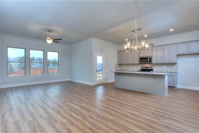 96 Sherwood Dr, Commerce, GA 30529 - kitchen with a wealth of natural light, gray cabinetry, stainless steel appliances, and baseboards