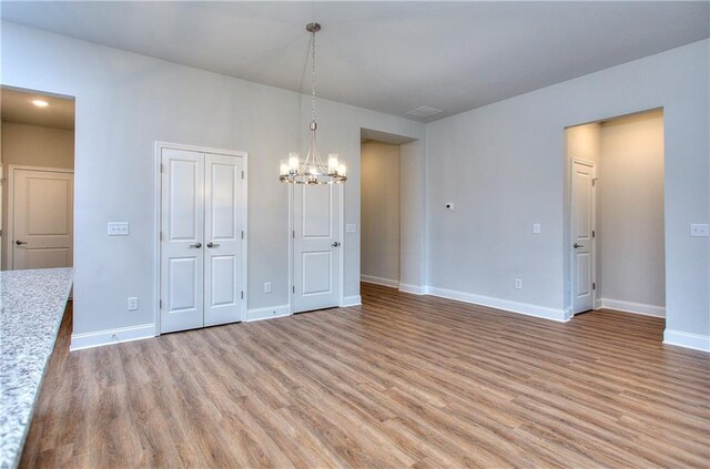 96 Sherwood Dr, Commerce, GA 30529 - unfurnished dining area featuring light wood-type flooring, baseboards, and a chandelier