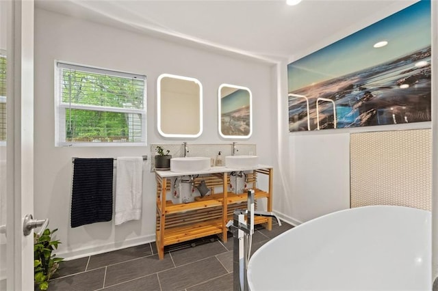 3143 Church St, East Point, GA 30344 - full bathroom with a freestanding tub, double vanity, and tile patterned floors