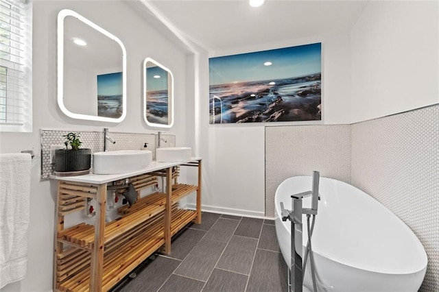 3143 Church St, East Point, GA 30344 - full bathroom with a freestanding tub, double vanity, recessed lighting, and decorative backsplash