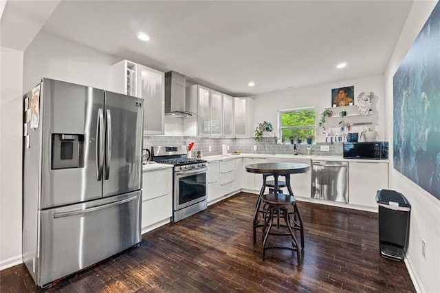 3143 Church St, East Point, GA 30344 - kitchen with appliances with stainless steel finishes, wall chimney range hood, light countertops, white cabinetry, and recessed lighting