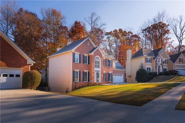 view of front of home with a garage and a front lawn