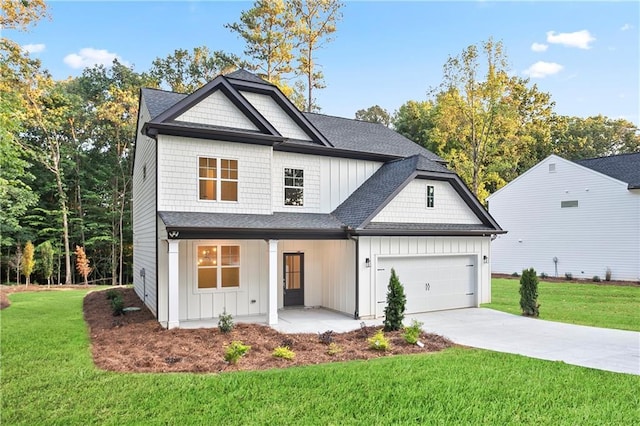 view of front of property with a front lawn, covered porch, and a garage