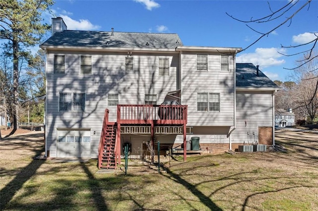 back of house with a yard, a chimney, a wooden deck, and stairs