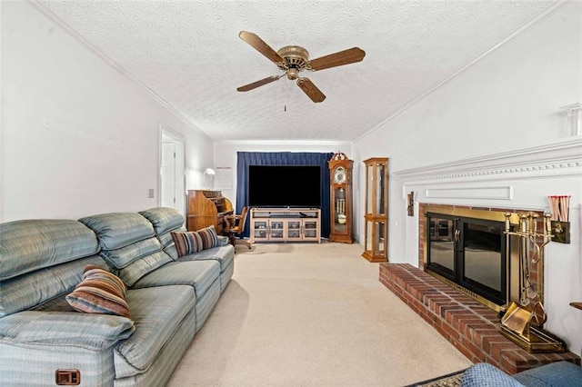 living area with a textured ceiling, carpet floors, ornamental molding, and a brick fireplace