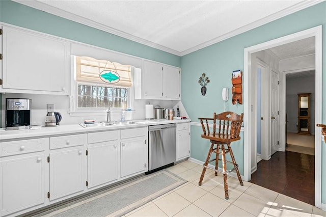 kitchen featuring a sink, white cabinetry, light countertops, and stainless steel dishwasher