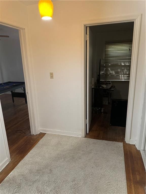 hallway with dark hardwood / wood-style floors