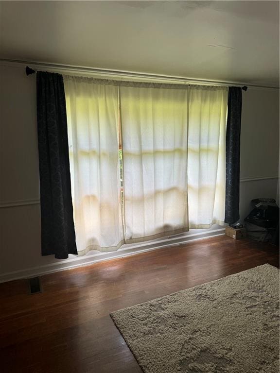 empty room featuring hardwood / wood-style flooring and a healthy amount of sunlight
