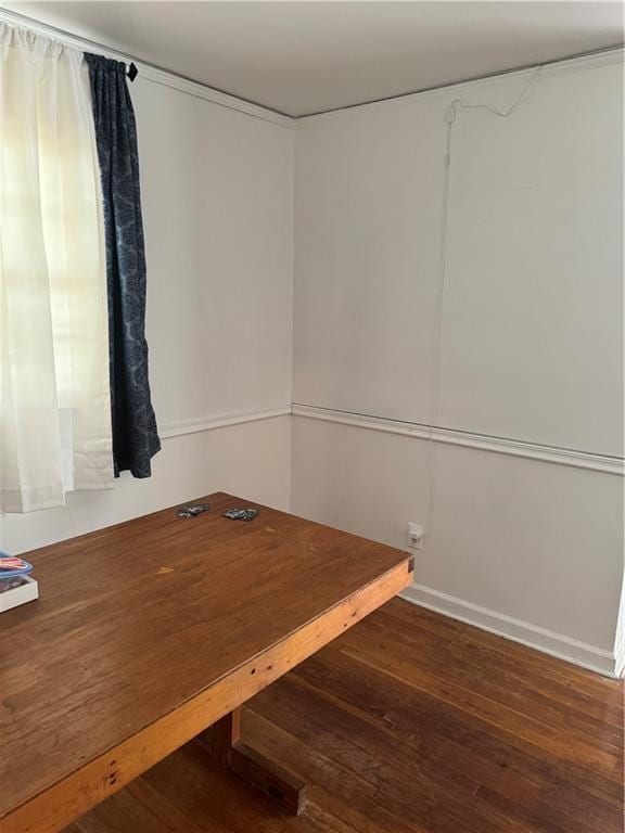 unfurnished dining area featuring dark wood-type flooring