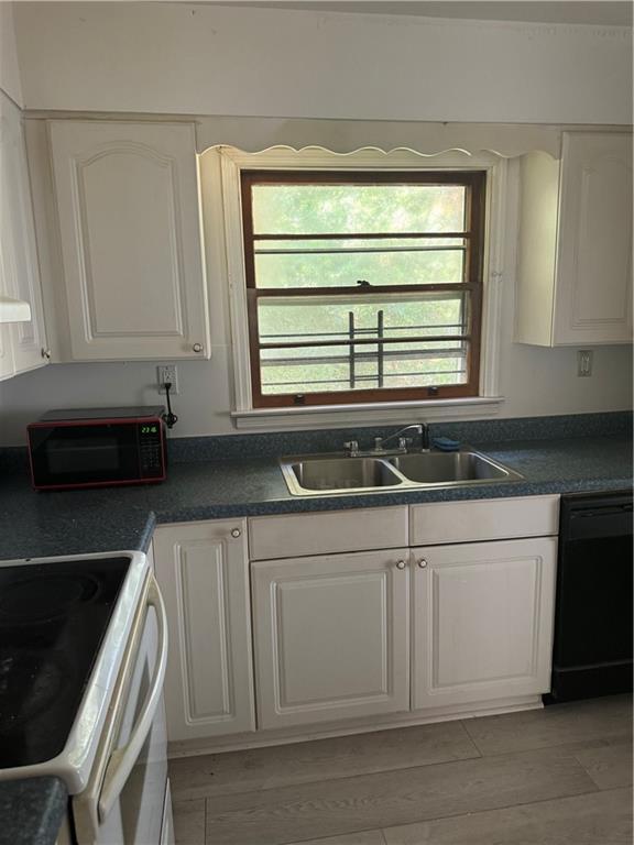 kitchen with sink, light hardwood / wood-style flooring, dishwasher, white cabinets, and white range with electric stovetop