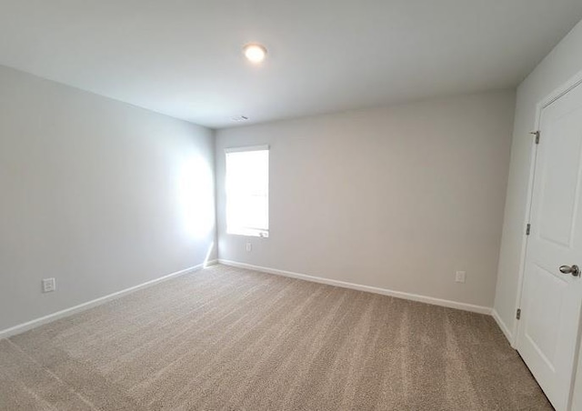 carpeted empty room with baseboards