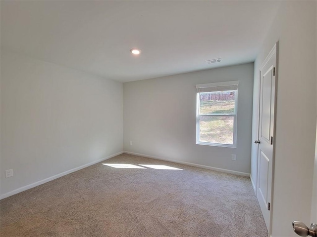 carpeted empty room with baseboards and recessed lighting
