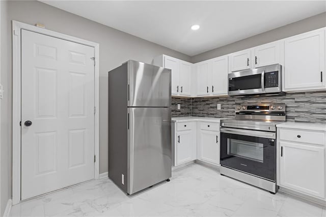 kitchen featuring white cabinetry, appliances with stainless steel finishes, and tasteful backsplash