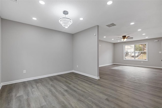 spare room featuring dark hardwood / wood-style floors and ceiling fan