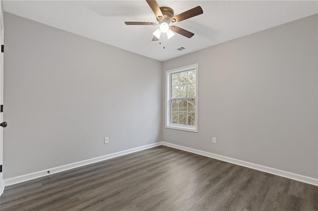 empty room with dark wood-type flooring and ceiling fan