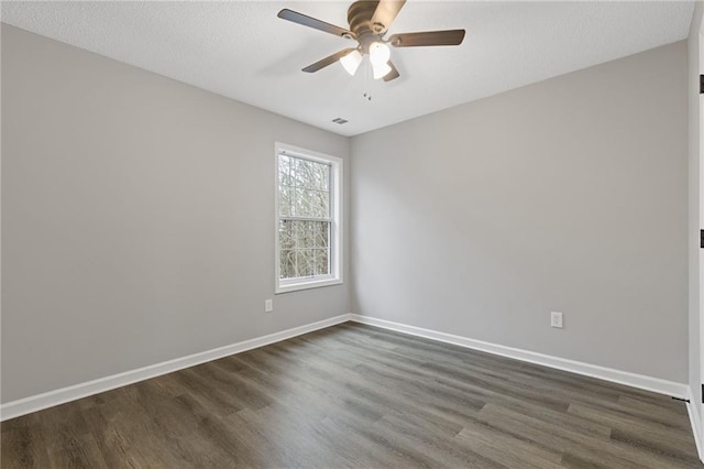 empty room with dark hardwood / wood-style floors and ceiling fan