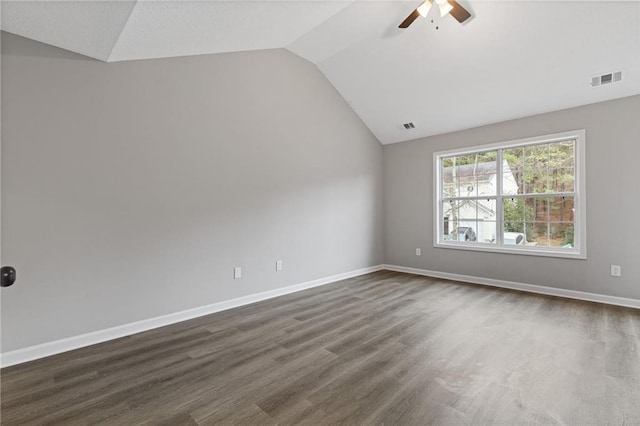 unfurnished room featuring lofted ceiling, dark hardwood / wood-style floors, and ceiling fan