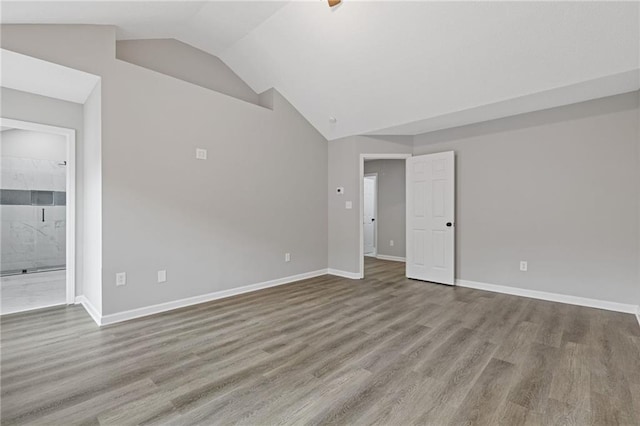 empty room featuring lofted ceiling and light wood-type flooring