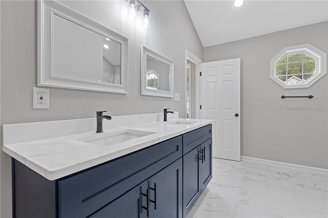 bathroom featuring lofted ceiling and vanity