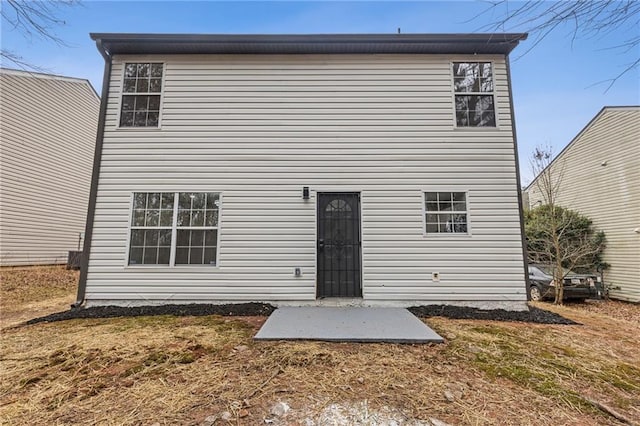 rear view of property with a yard and a patio