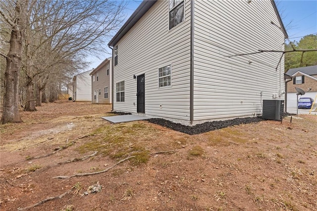 view of home's exterior with central AC unit and a patio