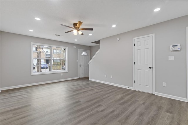 unfurnished living room with ceiling fan and light wood-type flooring