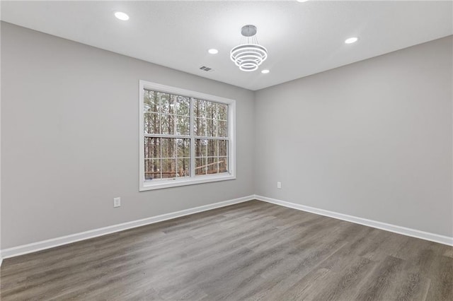 spare room featuring dark wood-type flooring