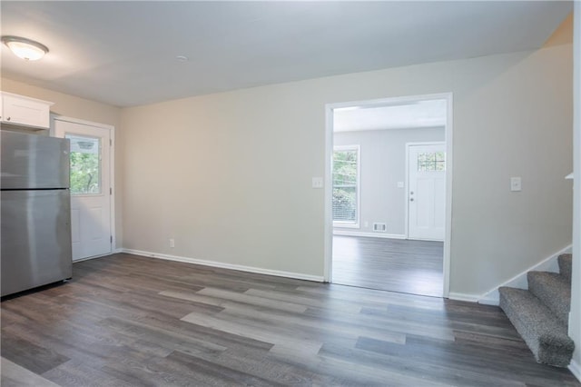 5795 Deerfield Trl, Atlanta, GA 30349 - unfurnished dining area with healthy amount of natural light, wood finished floors, baseboards, and stairs