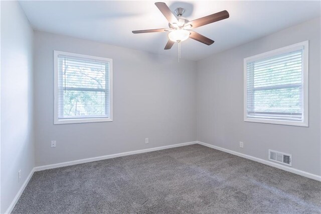 5795 Deerfield Trl, Atlanta, GA 30349 - unfurnished room featuring plenty of natural light, carpet, a ceiling fan, and baseboards