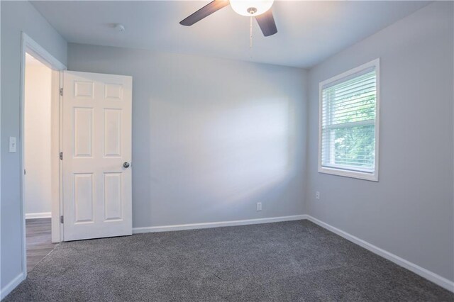 5795 Deerfield Trl, Atlanta, GA 30349 - empty room featuring carpet, baseboards, and ceiling fan