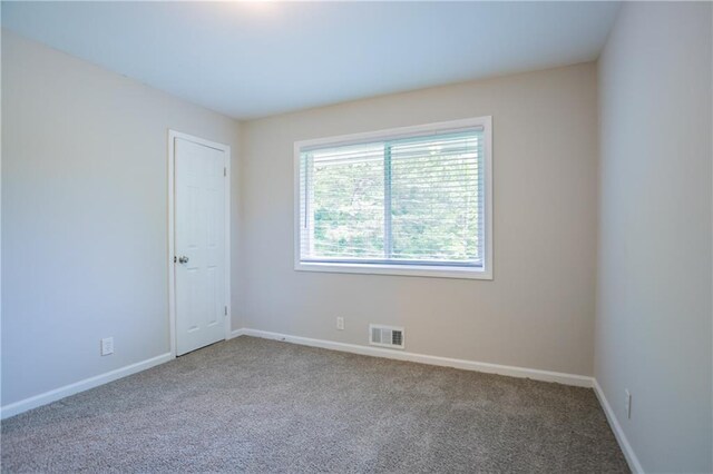 5795 Deerfield Trl, Atlanta, GA 30349 - spare room featuring carpet and baseboards