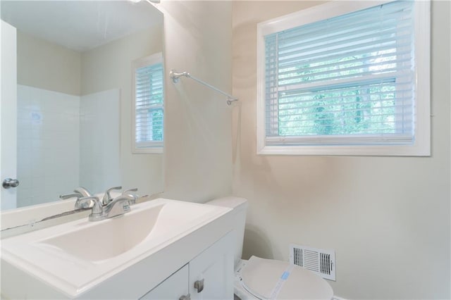 5795 Deerfield Trl, Atlanta, GA 30349 - bathroom featuring vanity, toilet, and a shower