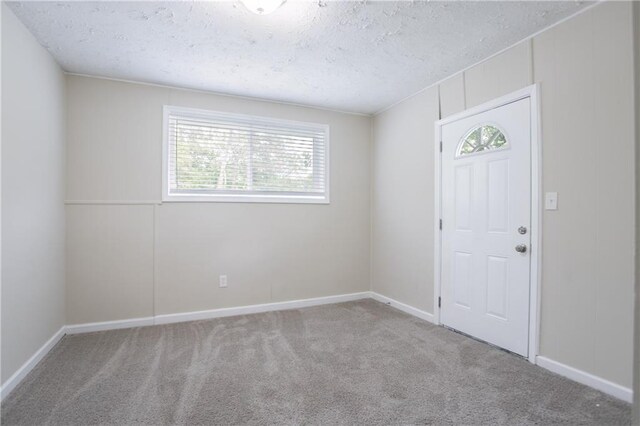 5795 Deerfield Trl, Atlanta, GA 30349 - foyer entrance with carpet flooring, a textured ceiling, and baseboards