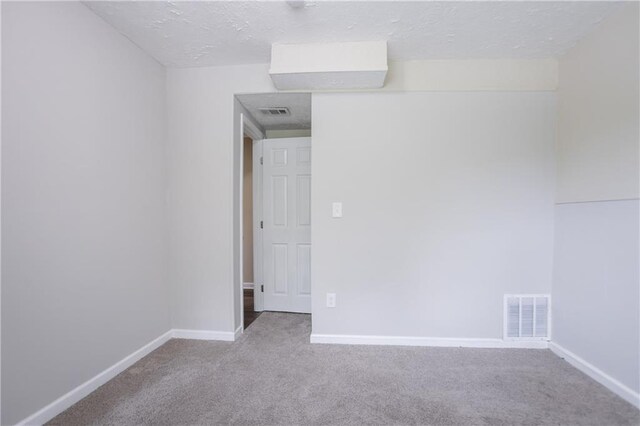 5795 Deerfield Trl, Atlanta, GA 30349 - carpeted spare room featuring baseboards and a textured ceiling