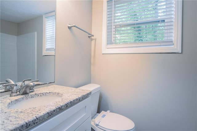 5795 Deerfield Trl, Atlanta, GA 30349 - bathroom featuring vanity, toilet, and a textured ceiling