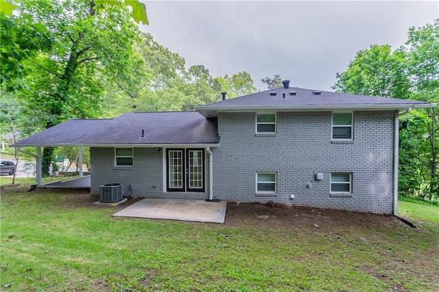 5795 Deerfield Trl, Atlanta, GA 30349 - rear view of property featuring a patio area, a lawn, brick siding, and central AC