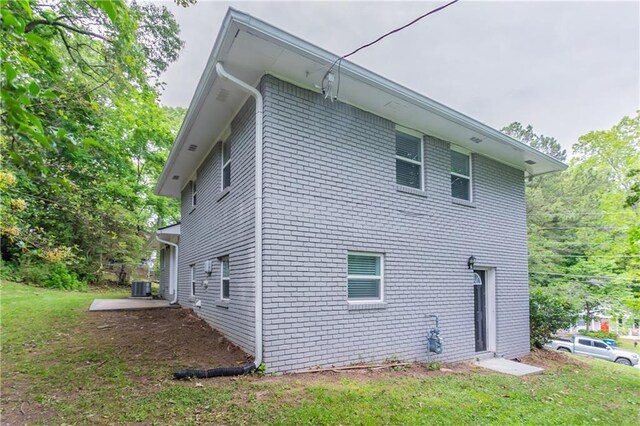 5795 Deerfield Trl, Atlanta, GA 30349 - view of side of property with central AC unit, a yard, and brick siding