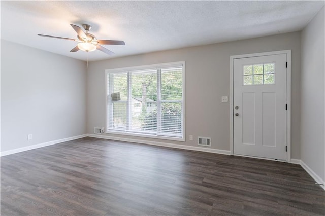 5795 Deerfield Trl, Atlanta, GA 30349 - entrance foyer featuring dark wood-type flooring, baseboards, a ceiling fan, and a textured ceiling