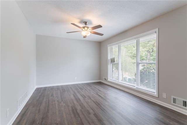 5795 Deerfield Trl, Atlanta, GA 30349 - empty room featuring dark wood-style flooring, ceiling fan, baseboards, and a textured ceiling