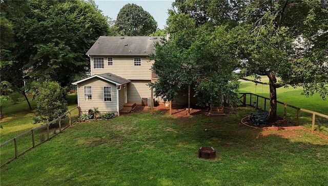 5624 Ryan Way, Flowery Branch, GA 30542 - back of property with a fenced backyard and a fire pit
